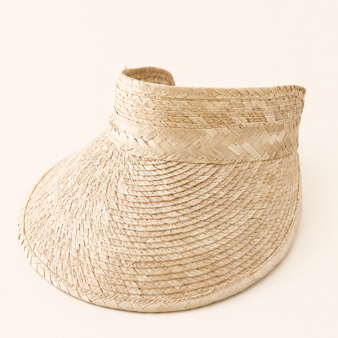 Beige straw visor on a white background