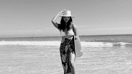 Slow fashion designer, Bria Robles, wearing a Räys by the Ocean sarong, Leah Bo Rancher straw hat and Luna oversized tote bag