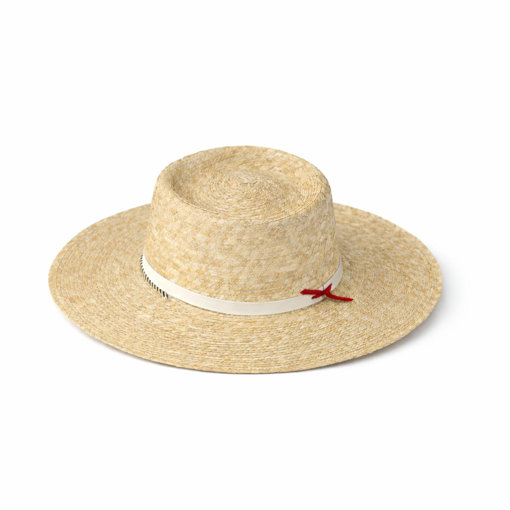 Straw hat with a white band and red bow on a white background