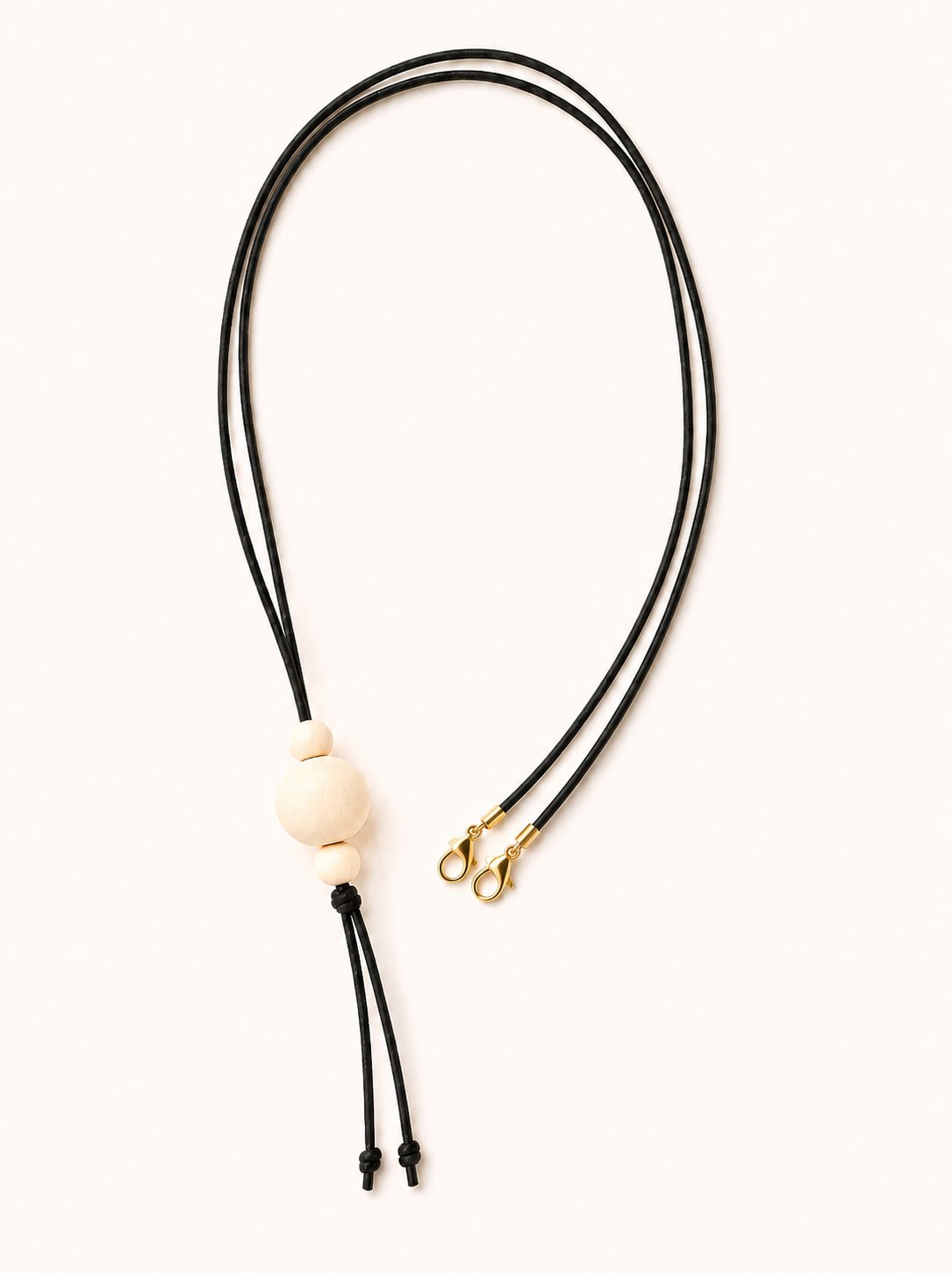  a black cord and a wooden bead  on a white background