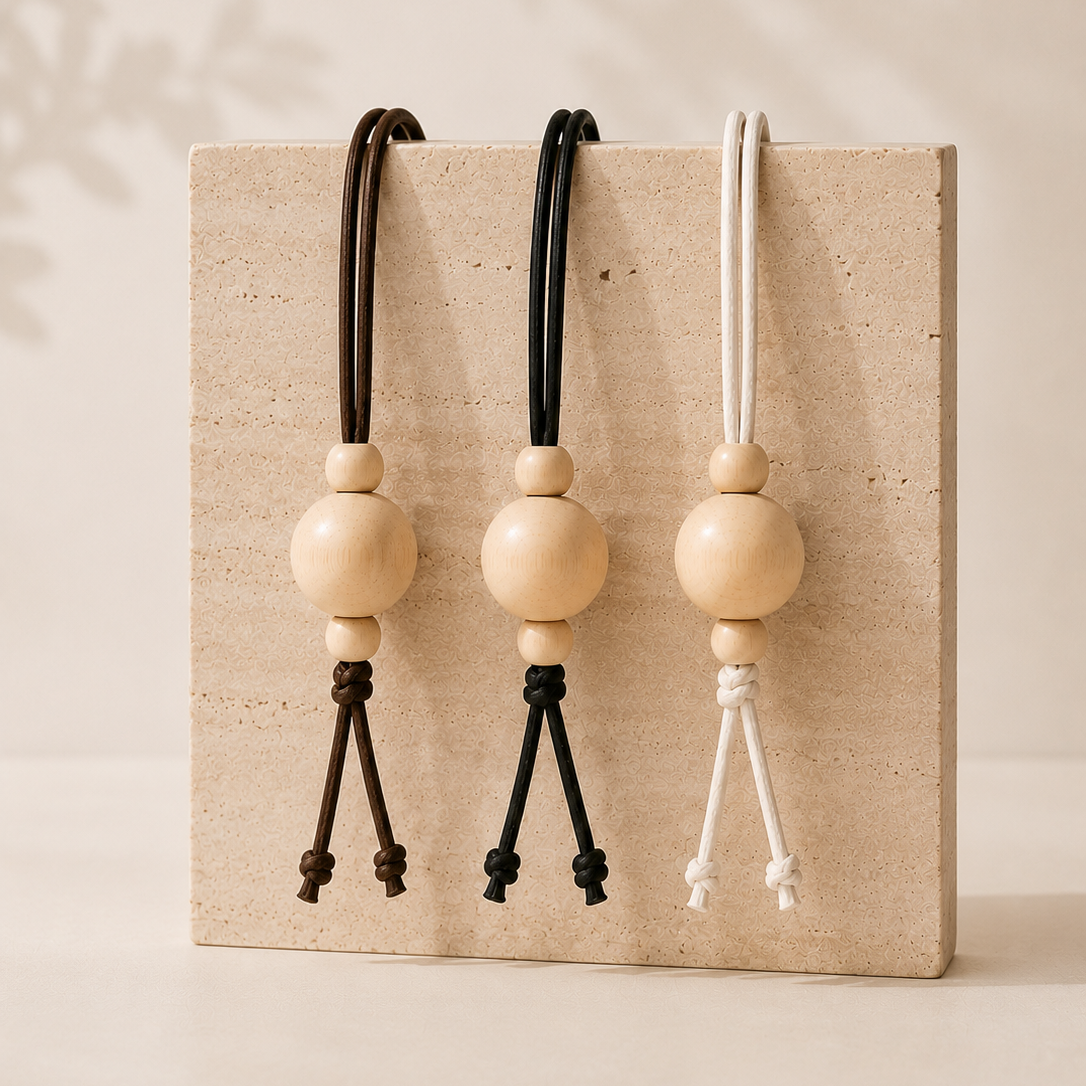 Three wooden beads with black, brown and white waxed cotton chin cord 