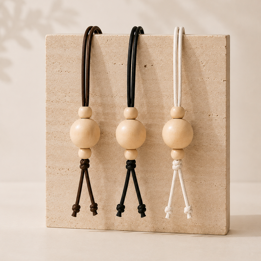 Three wooden beads with black, brown and white waxed cotton chin cord 