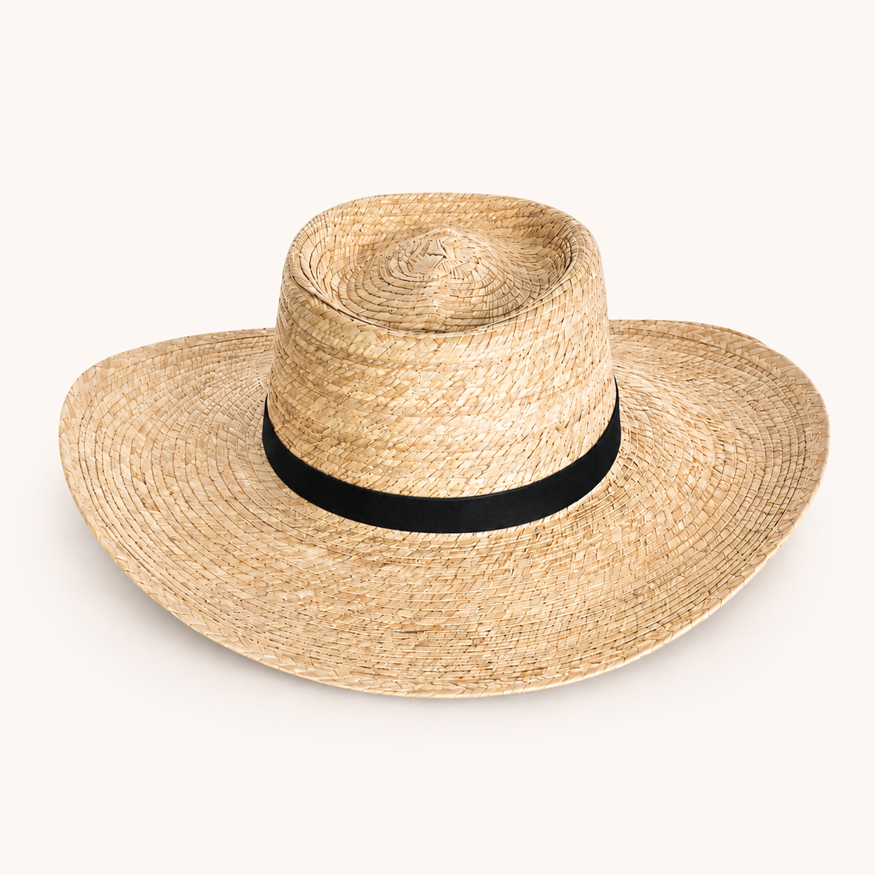 Straw hat with a black band on a white background