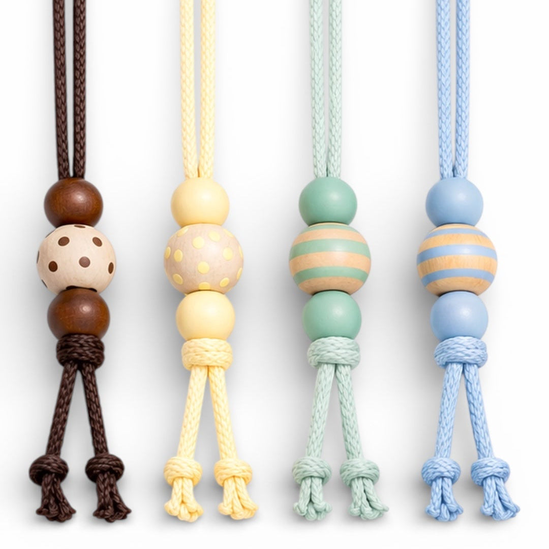 Set of four colorful chin straps with bead designs on a white background