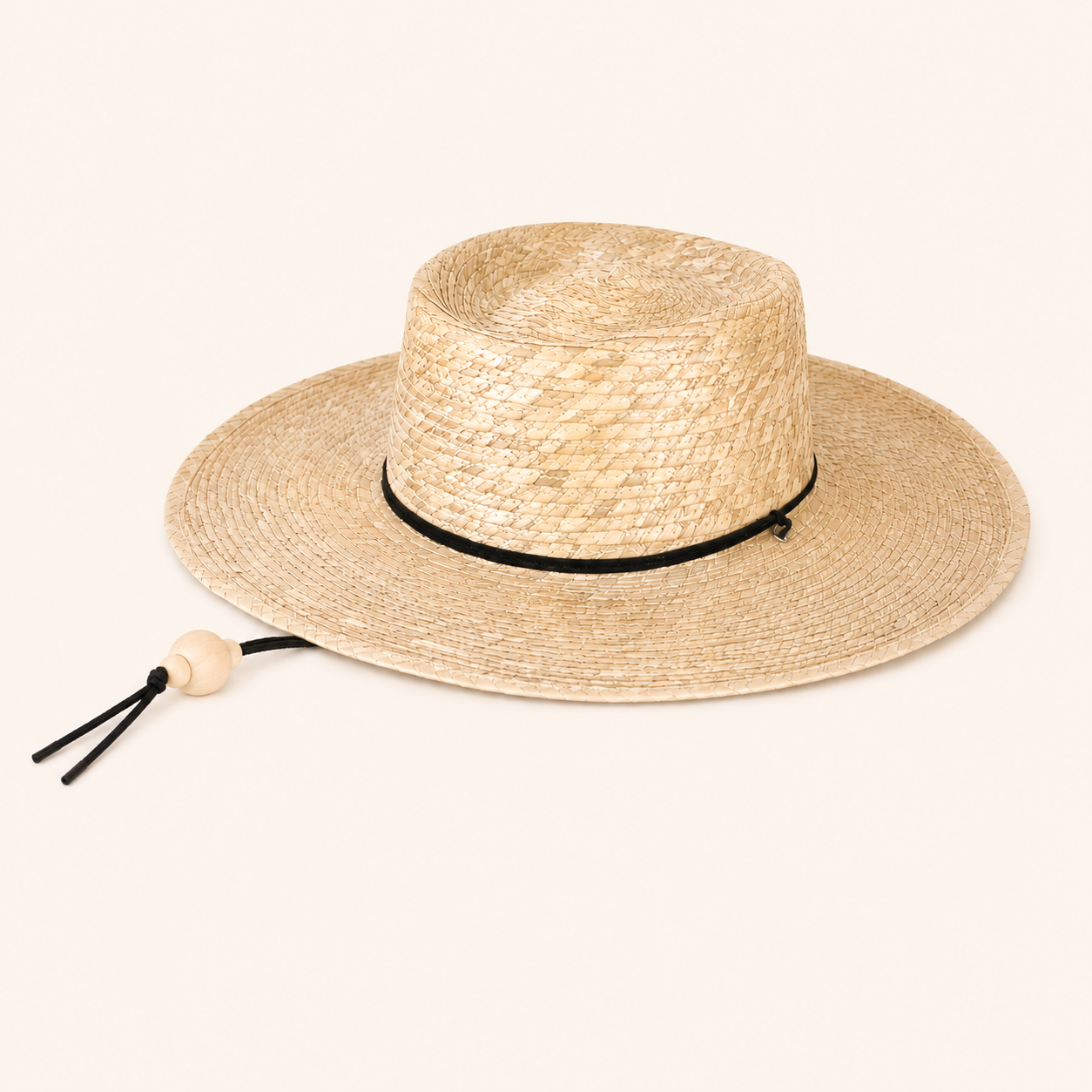 Beige straw hat with a black band on a white background